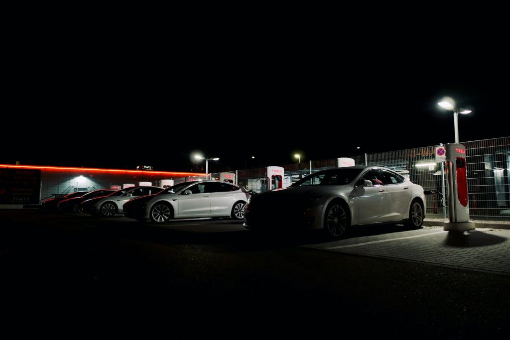 teslas charging at night station